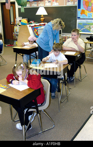 Pregnant woman teacher conducts lessons in her third grade classroom Stock Photo