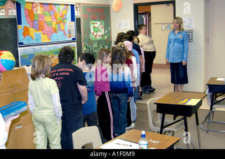 Pregnant woman teacher conducts lessons in her third grade classroom Stock Photo