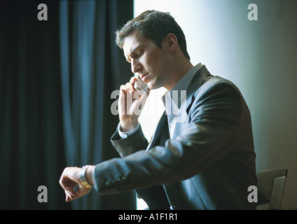 Businessman checking watch Stock Photo