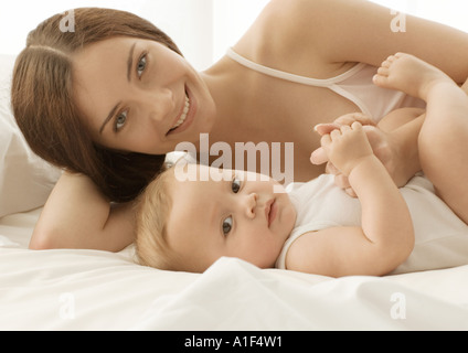 Baby and mother on bed, portrait Stock Photo