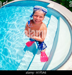 White 10 year old boy in pool with scuba mask fins Stock Photo