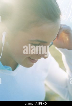 Teenage girl listening to earphones Stock Photo