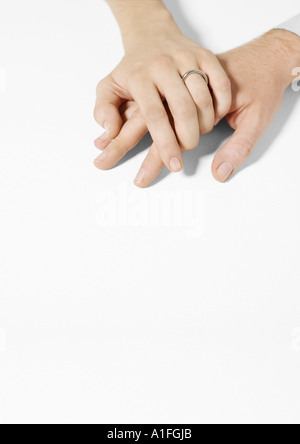 Woman wearing wedding ring clasping man's hand Stock Photo