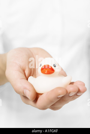 Hand holding rubber duck Stock Photo