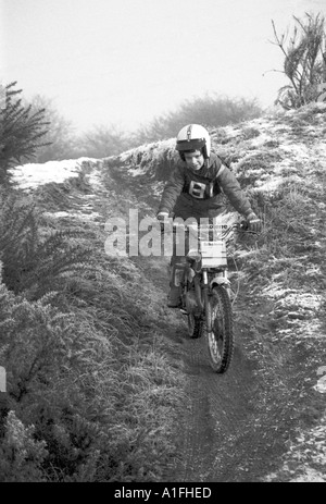 Young male child on trials motor bike in country after fall of snow Stock Photo