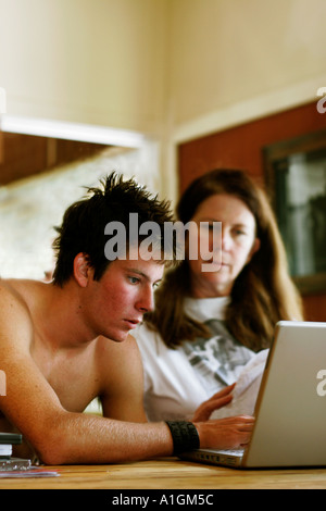 Mother and son work on computer together Stock Photo