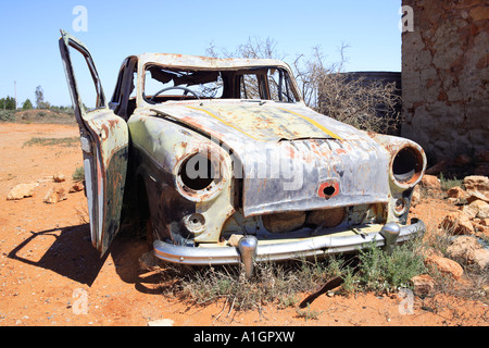 Derelict car next to old water tank and ruins, Silverton near Broken, Hill New South Wales, Australia Stock Photo