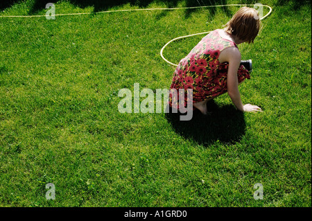 Young Girl Playing With Sprinkler