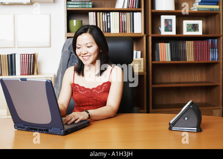 Close-up of a businesswoman using a laptop smiling Stock Photo