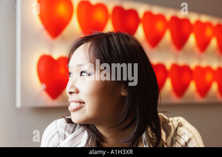 Close-up of a young woman looking sideways smiling Stock Photo