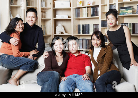 Portrait of two young men and four young women on a couch Stock Photo