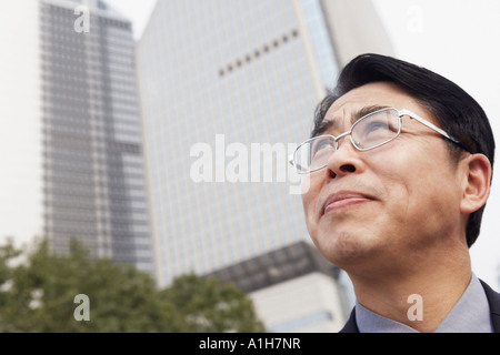 Low angle view of a businessman looking up thinking Stock Photo