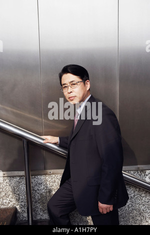 Portrait of a businessman walking up a staircase Stock Photo