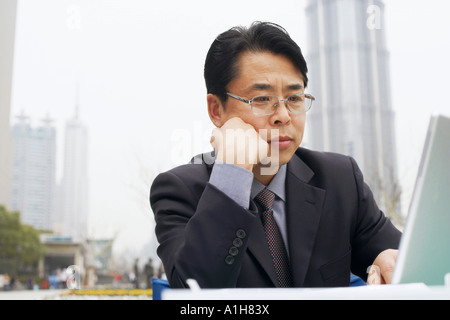 Close-up of a businessman using a laptop Stock Photo