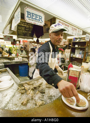 Shucking oysters at John W Faidley Seafood Lexington Market Baltimore Maryland Stock Photo