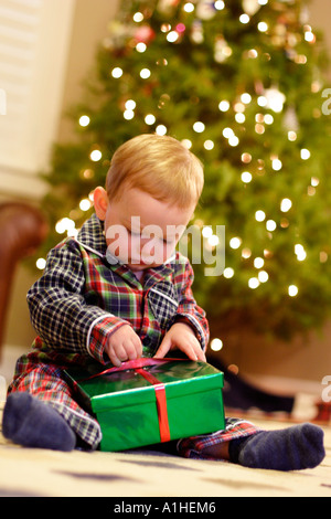 18 month old boy opening presents on Christmas morning. Stock Photo