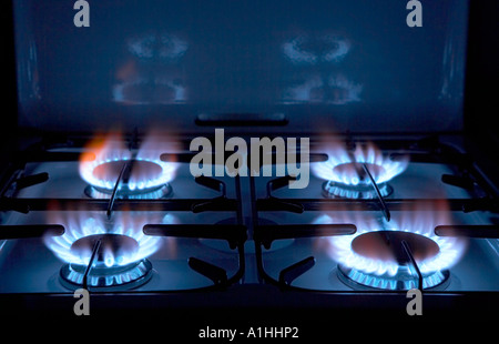 FOUR BURNING RINGS ON GAS COOKER HOB Stock Photo