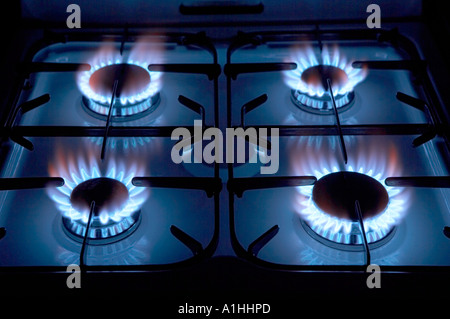 FOUR BURNING RINGS ON GAS COOKER HOB Stock Photo