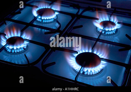 FOUR BURNING RINGS ON GAS COOKER HOB Stock Photo