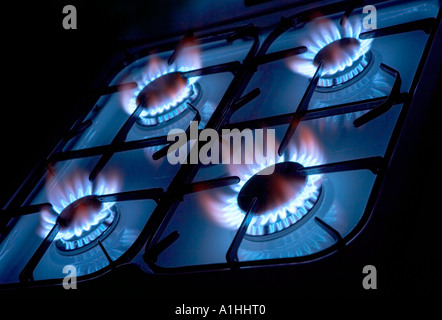 FOUR BURNING RINGS ON GAS COOKER HOB Stock Photo