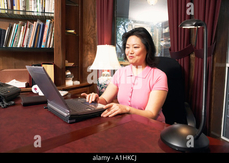 High angle view of a mature woman using a laptop Stock Photo