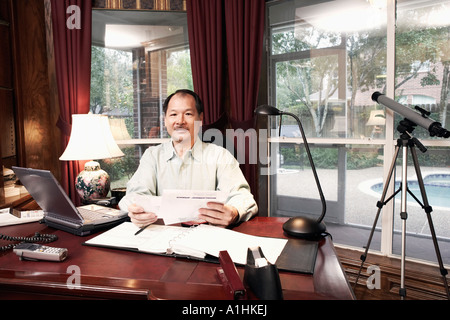 Portrait of a senior man holding a letter Stock Photo