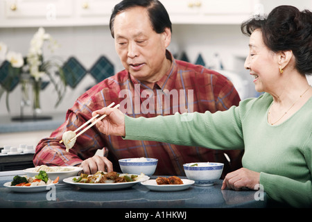 Close-up of a senior couple sitting at a table Stock Photo