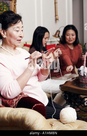 Close up older woman knitting, sitting on sofa at home Stock Photo - Alamy