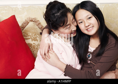 Portrait of a girl hugging her grandmother Stock Photo