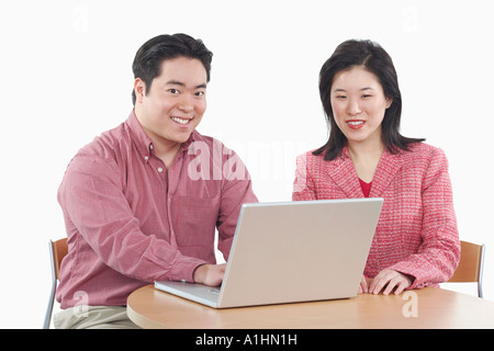 Portrait of a businessman and a businesswoman using a laptop Stock Photo