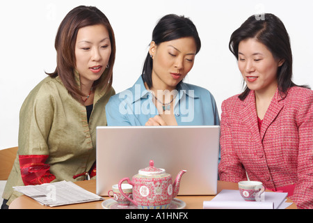 Close-up of three businesswomen in front of a laptop Stock Photo