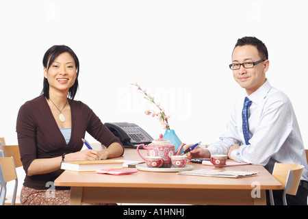 Portrait of a businessman and a businesswoman smiling Stock Photo