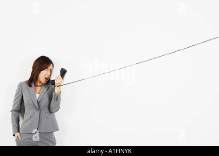Businesswoman yelling on the telephone Stock Photo