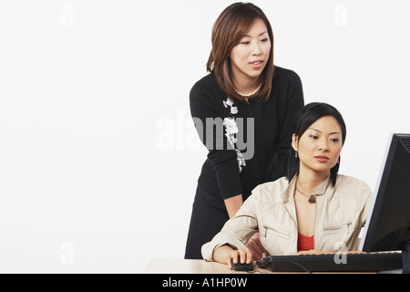 Close-up of two businesswomen using a computer Stock Photo