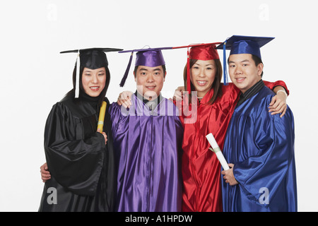 Portrait of two male and two female graduates Stock Photo