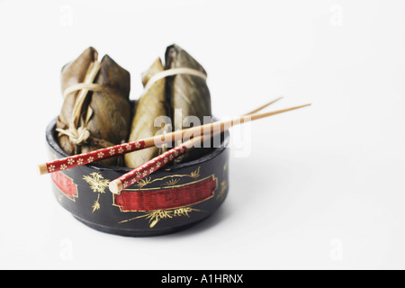 High angle view of food in a bowl with a pair of chopsticks Stock Photo