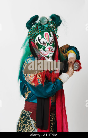 Close-up of a male Chinese opera performer holding a sword Stock Photo