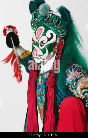 Portrait of a male Chinese opera performer holding a weapon Stock Photo