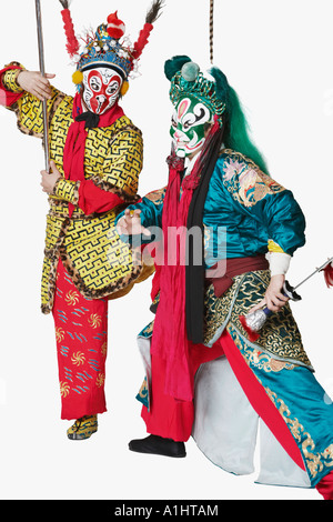 Two male Chinese opera performers gesturing with weapons Stock Photo ...