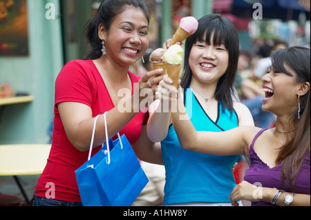 Close-up of three young women holding ice-cream cones Stock Photo
