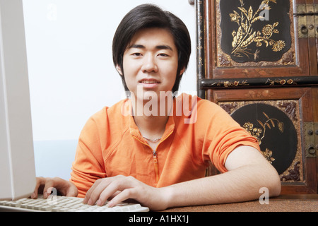 Portrait of a young man using a computer Stock Photo