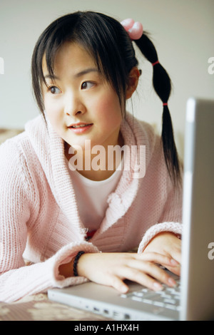 Close-up of a young woman using a laptop Stock Photo