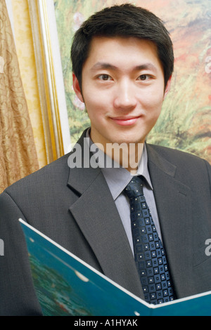 Portrait of a businessman holding a file smiling Stock Photo