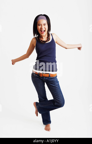 Portrait of a young woman standing on one leg Stock Photo