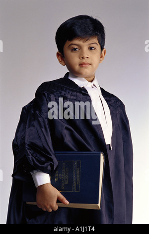 Young boy in fancy dress of Judge with copy of The Constitution of India MR#499 Stock Photo