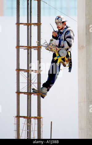 Construction workers with protective clothing and hard hats work on building in Sarasota Florida Stock Photo