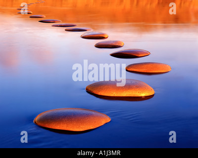 Stepping stones provide a safe passage through deep water Stock Photo