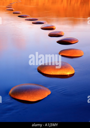 Stepping stones provide a safe passage through deep water Stock Photo