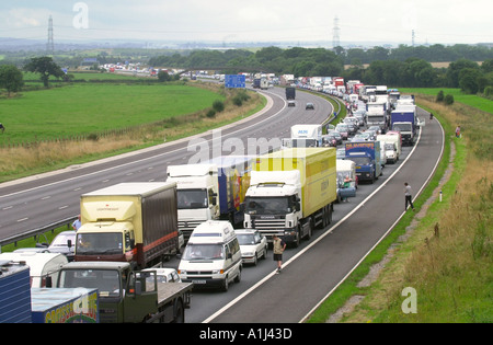PASSENGERS GET OUT OF THEIR CARS IN HOLIDAY TRAFFIC STUCK ON THE M5 NEAR BRISTOL UK