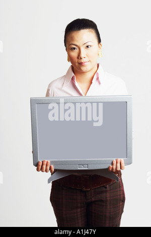 Portrait of a businesswoman holding the model of a computer monitor with progress reports Stock Photo